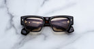 Jacques Marie Mage Agar sunglasses in dark tortoise acetate featuring a bold rectangular frame, warm tinted lenses, and signature arrowhead front pins, front view