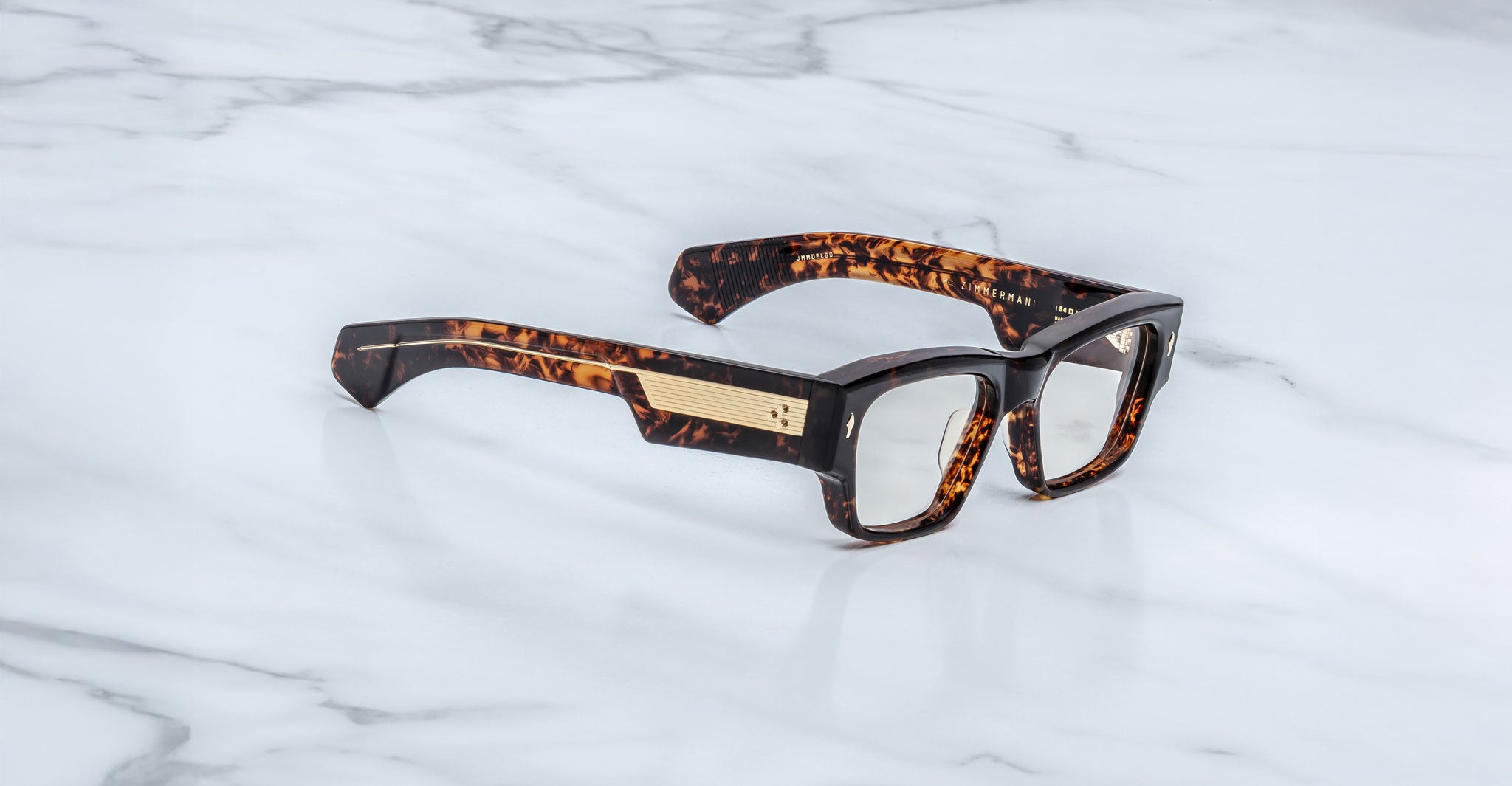 Jacques Marie Mage Agar optical glasses in tortoise acetate with bold rectangular frame, clear lenses, and wide temples with signature metal core detail, angled view