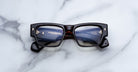 Jacques Marie Mage Agar optical glasses in dark tortoise acetate with bold rectangular frame, clear lenses, and signature arrowhead front pins, front view