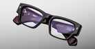 Jacques Marie Mage Zimmerman optical glasses in Bloodstone black acetate with bold rectangular frame, clear lenses, and signature arrowhead front pins, angled front view