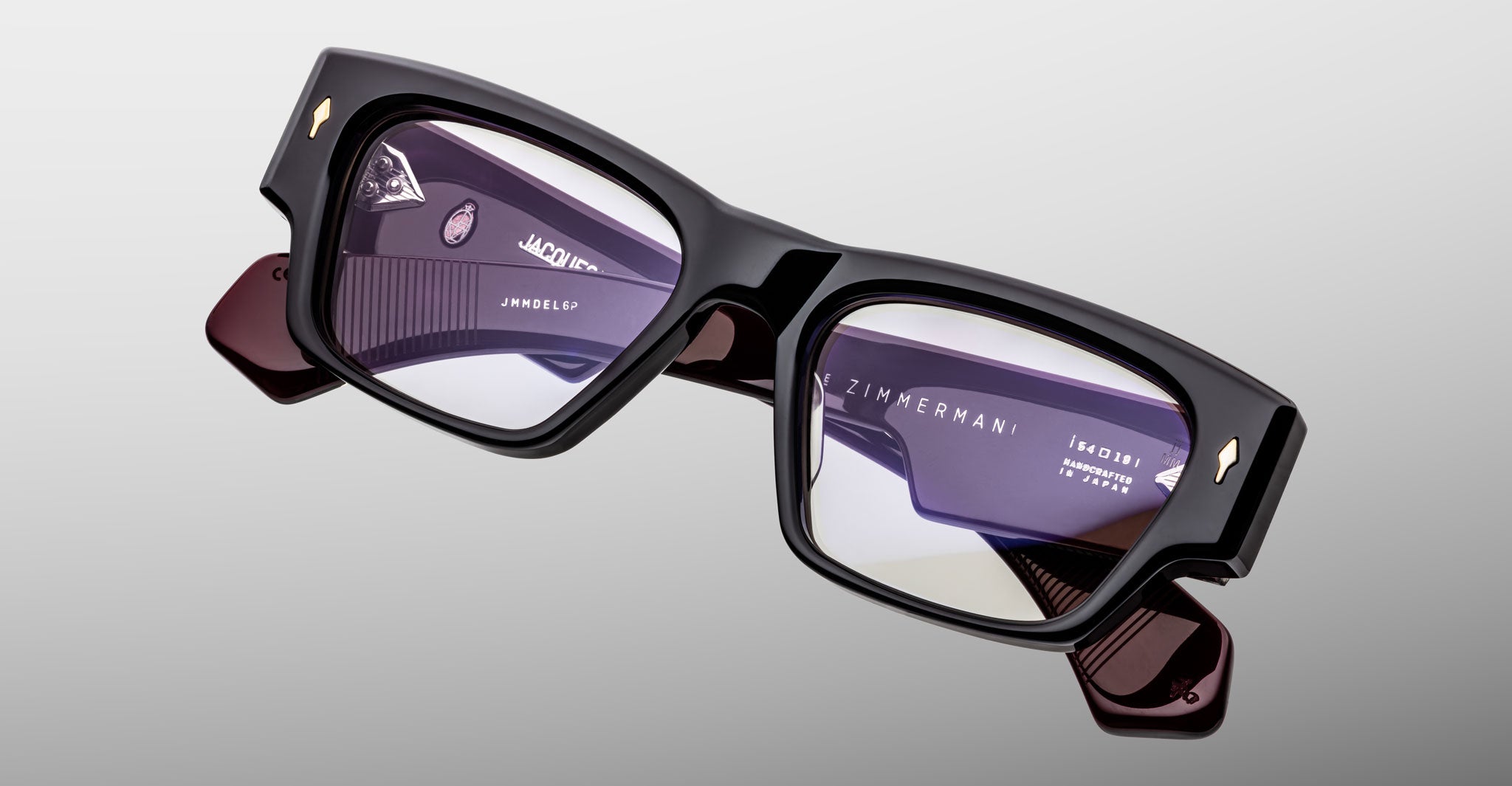 Jacques Marie Mage Zimmerman optical glasses in Bloodstone black acetate with bold rectangular frame, clear lenses, and signature arrowhead front pins, angled front view