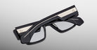 Jacques Marie Mage Zimmerman optical glasses in Bloodstone black acetate with bold rectangular frame, clear lenses, and wide temples with signature metal core detail, back view