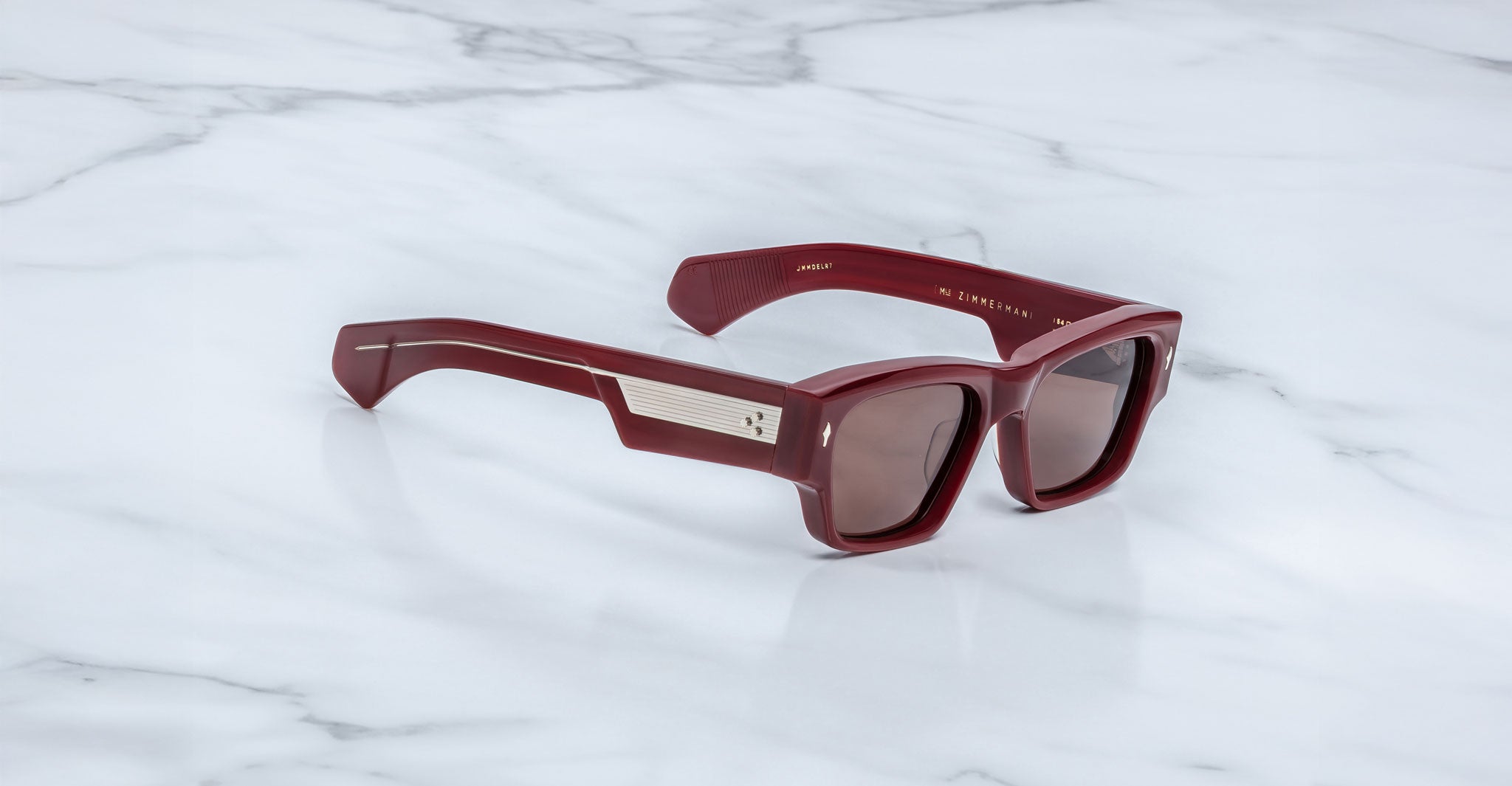 Jacques Marie Mage Zimmerman sunglasses in Bordeaux Empire red acetate with bold rectangular frame, brown tinted lenses, and wide temples with signature metal core detail, angled view