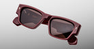 Jacques Marie Mage Zimmerman sunglasses in Bordeaux Empire red acetate with bold rectangular frame, brown tinted lenses, and signature arrowhead front pins, angled front view