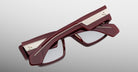 Jacques Marie Mage Zimmerman optical glasses in Bordeaux Empire red acetate with bold rectangular frame, clear lenses, and wide temples with signature metal wirecore detail, back view