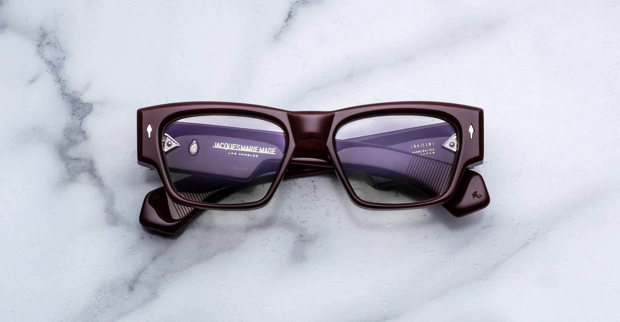 Jacques Marie Mage Zimmerman optical glasses in Bordeaux Empire red acetate with bold rectangular frame, clear lenses, and signature arrowhead front pins, front view