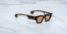 Jacques Marie Mage Zimmerman sunglasses in London brown acetate with bold rectangular frame, brown tinted lenses, and wide temples with signature metal wirecore detail, angled view