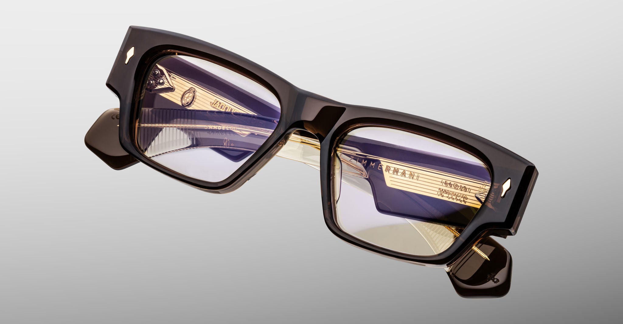 Jacques Marie Mage Zimmerman optical glasses in London brown acetate with bold rectangular frame, clear lenses, and signature arrowhead front pins, angled front view