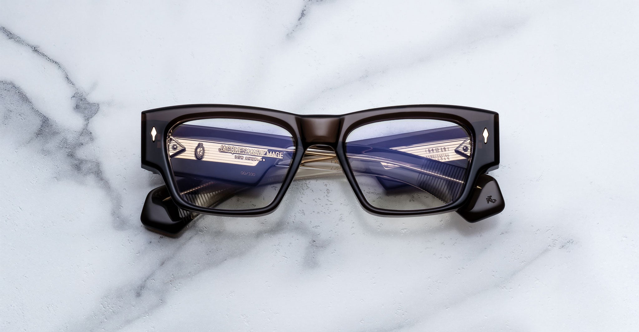 Jacques Marie Mage Zimmerman optical glasses in London brown acetate with bold rectangular frame, clear lenses, and signature arrowhead front pins, front view