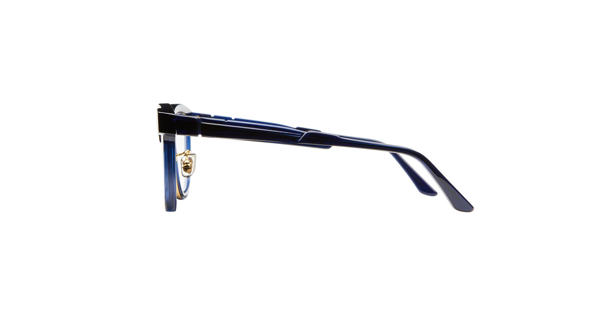 Side view of a pair of dark blue eyeglasses with clear nose pads, shown against a plain white background.