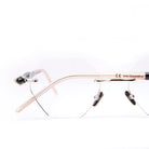 Close-up of rimless, geometric eyeglasses with transparent lenses and thin, light-colored arms against a white background. The brand name “Livio Grazottin” is visible on the arm.