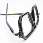 Kuboraum P8 eyeglasses by KUBORAUM in black with geometric frames and gold hinges, close-up front angle.