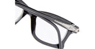 Close-up of Kuboraum D75 black eyeglass frames with a glossy finish and clear lenses, featuring a silver metallic Iron Man helmet detail on the temple.
