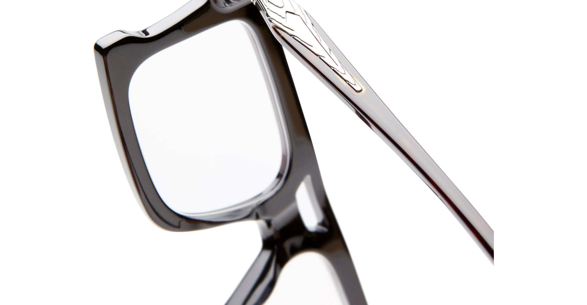 Close-up of KUBORAUM D76 eyeglasses showing black frames and gold temple detail, front angle.