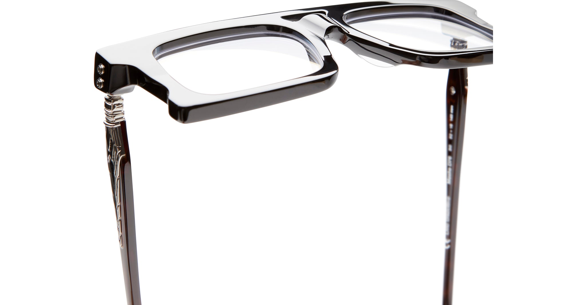 Close-up of KUBORAUM Kuboraum D76 black thick-rimmed eyeglasses, featuring metal temple accents, front angle.