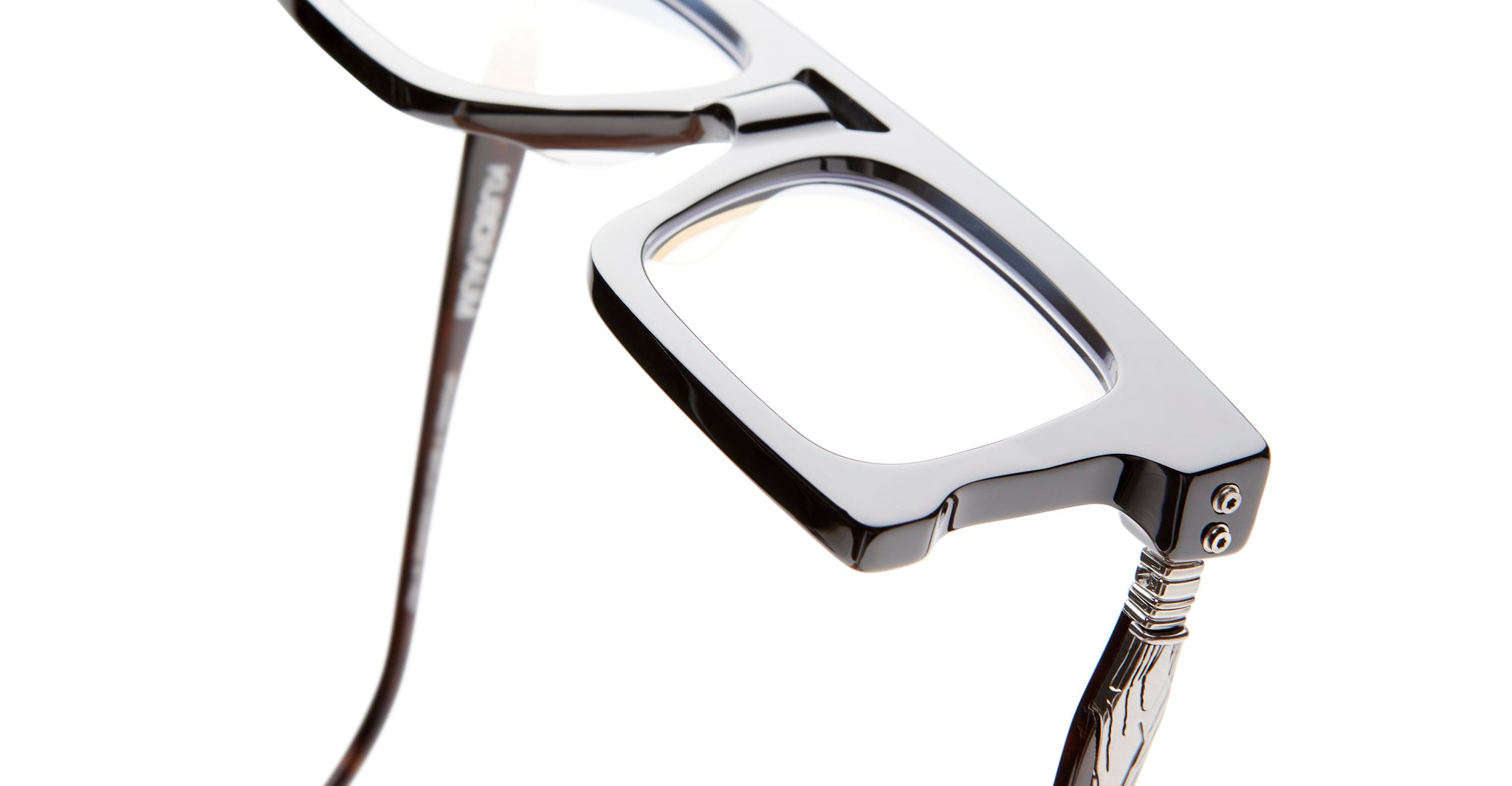 Close-up of KUBORAUM D76 black rectangular eyeglasses with clear lenses, showing thick frames and modern design.