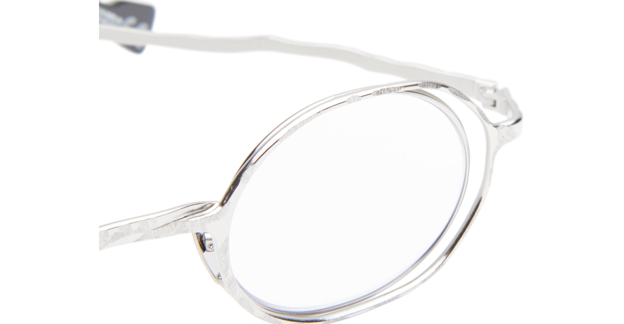 Close-up of the Kuboraum H11 silver eyeglasses, showcasing their round lenses and textured, wavy frame design, with focus on the right lens and temple against a white background.