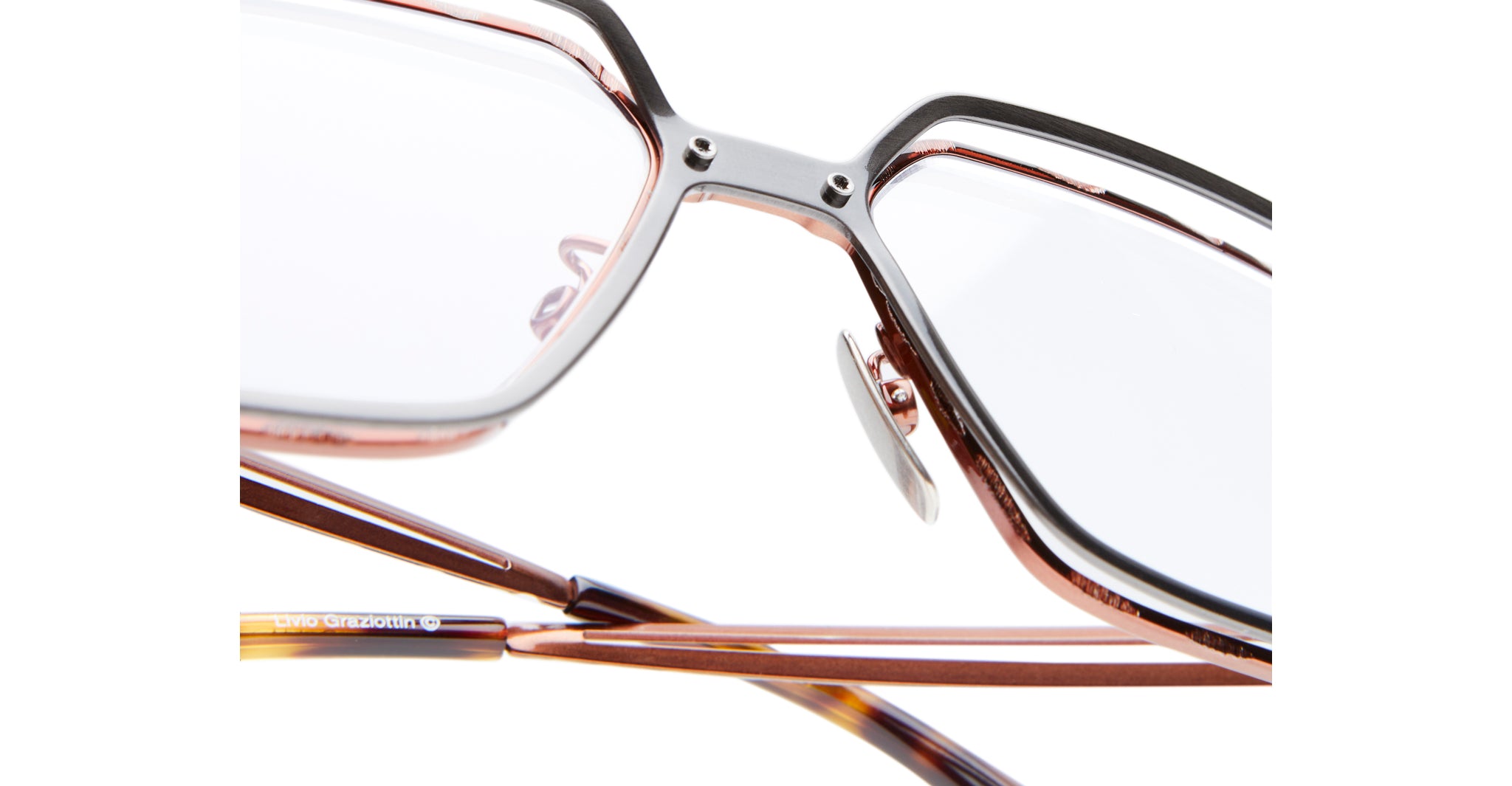 Close-up of Kuboraum H15 eyeglasses with brown frames and clear lenses, highlighting the nose pads and arms against a white background.