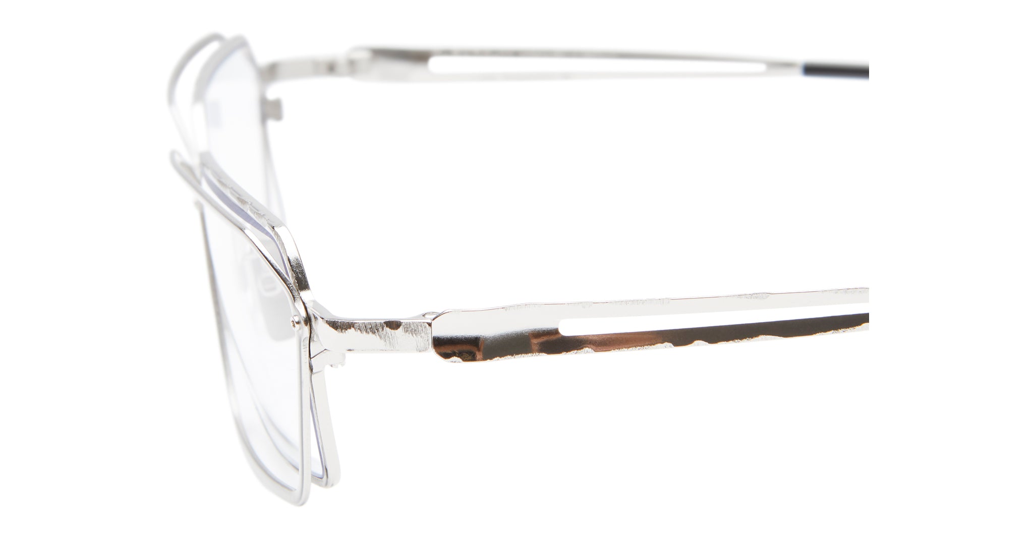 Close-up side view of Kuboraum H15 eyeglasses featuring a silver metal, thin rectangular frame with cut-out detailing along the arm, set against a white background.