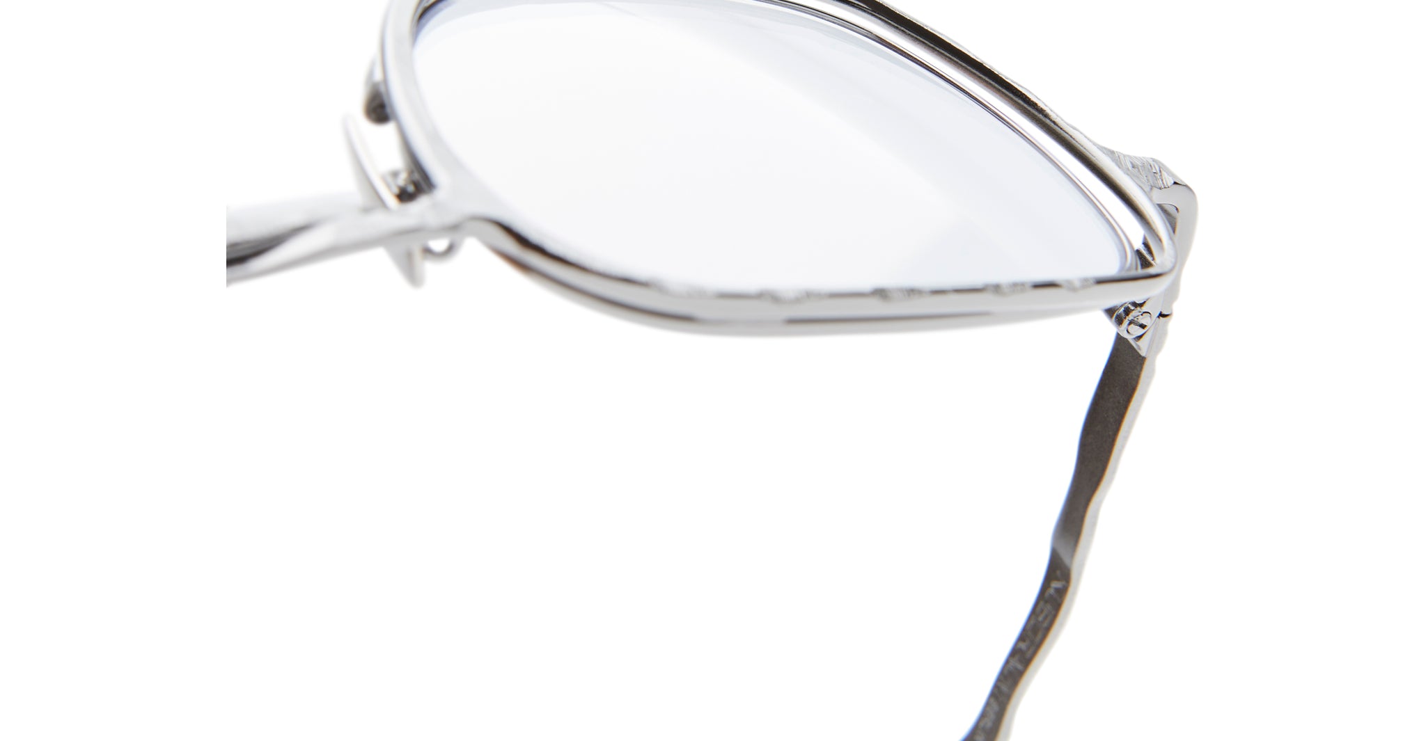 Close-up of the top-left portion of Kuboraum H22 eyeglasses featuring a shiny silver metal frame, clear lenses, and a wavy temple arm against a white background.