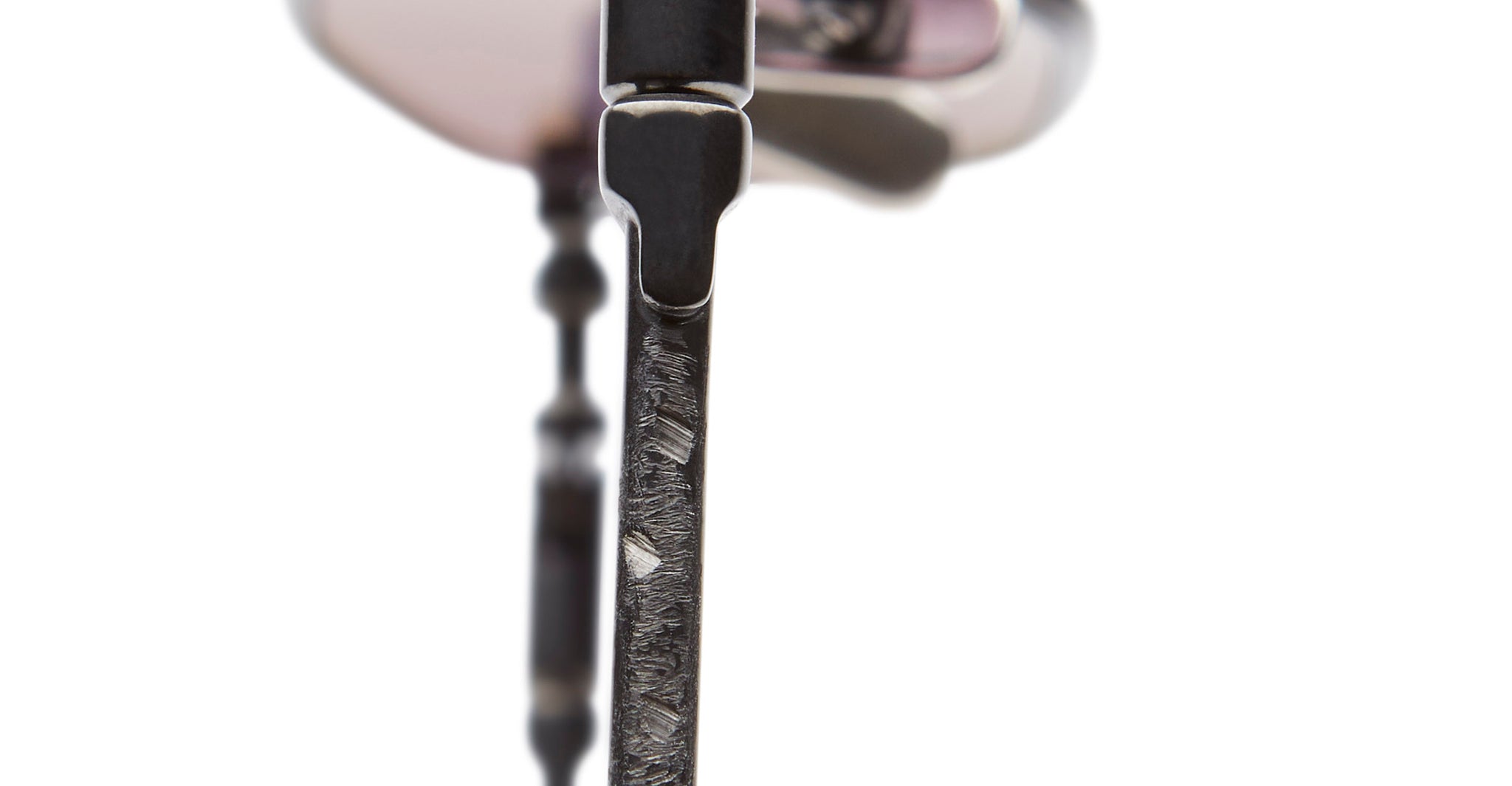 Close-up view of KUBORAUM H66 eyeglasses, showing the textured metal arm and hinge with visible wear from a side angle.