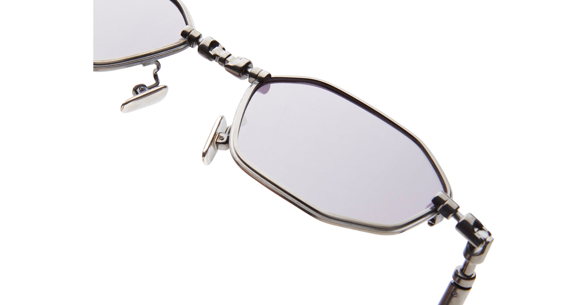 Close-up view of KUBORAUM H66 geometric metal sunglasses featuring tinted lenses and adjustable nose pads.