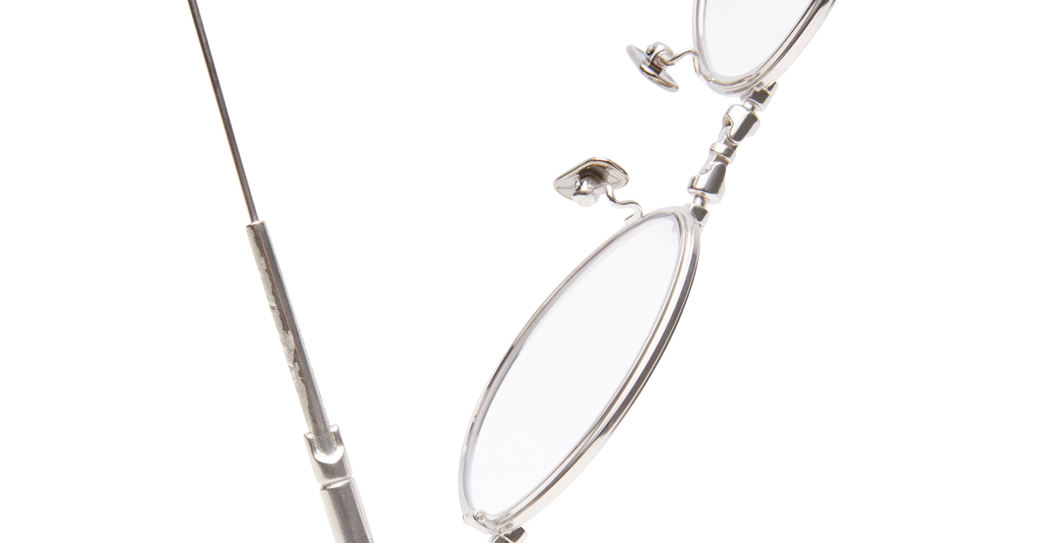 Close-up of a small screwdriver loosening hinge on KUBORAUM H67 eyeglasses, side view, showing precise adjustment.