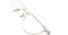 Close-up of KUBORAUM H67 silver-rimmed eyeglasses with transparent lenses, front view.
