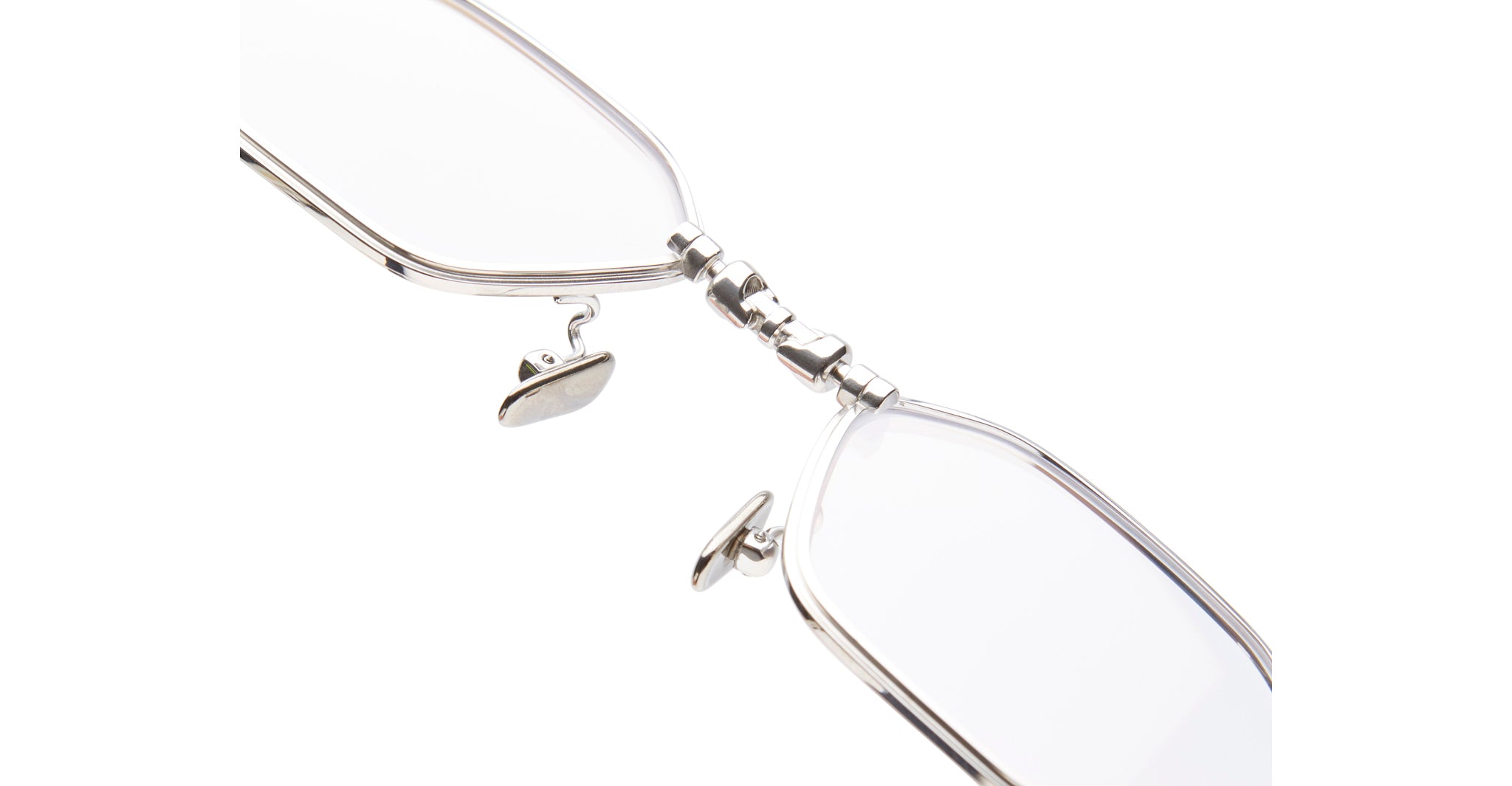 Close-up of KUBORAUM Kuboraum H66 metal eyeglasses bridge and adjustable nose pads, front view.