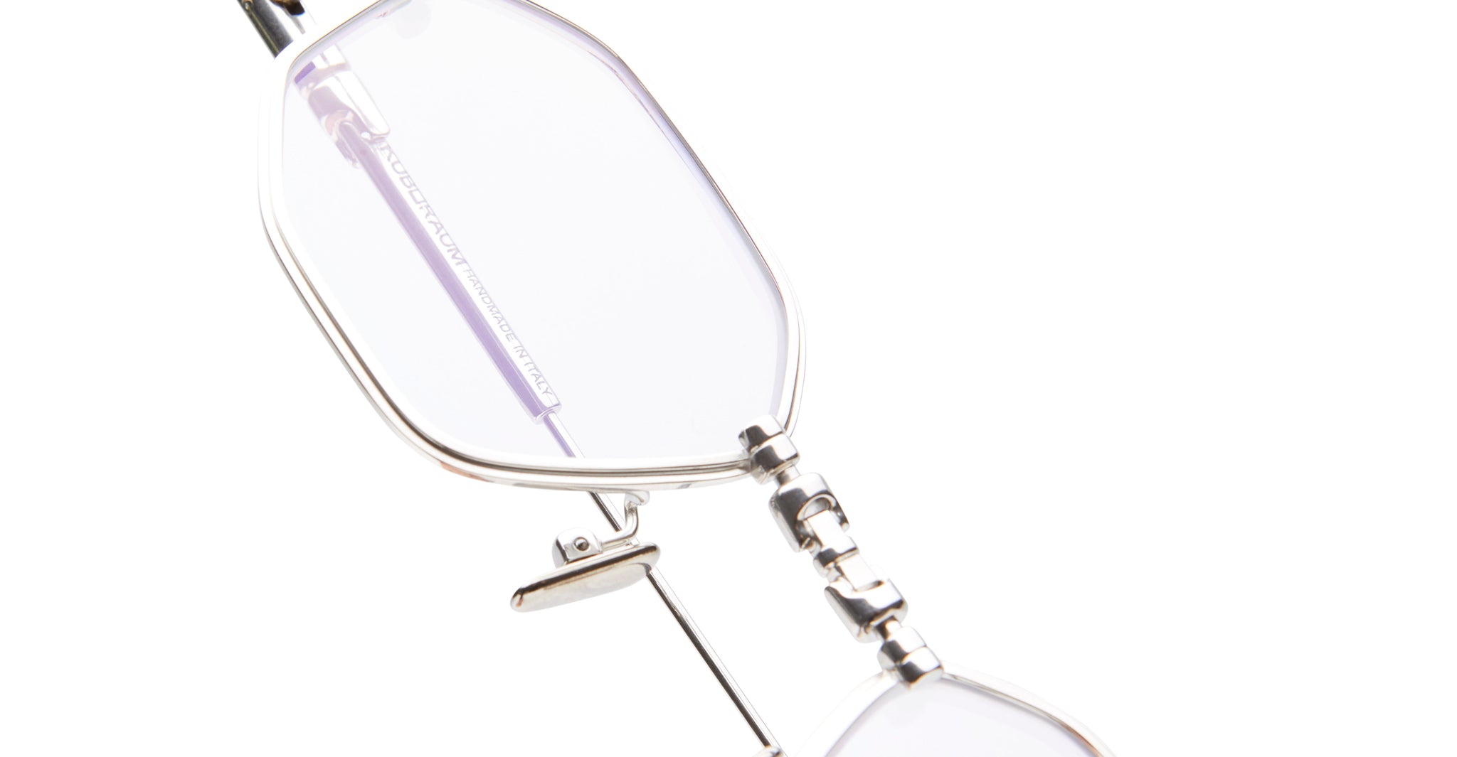 Close-up view of KUBORAUM H66 silver eyeglasses, showing oval lenses, visible hinge, and minimalist frame design.