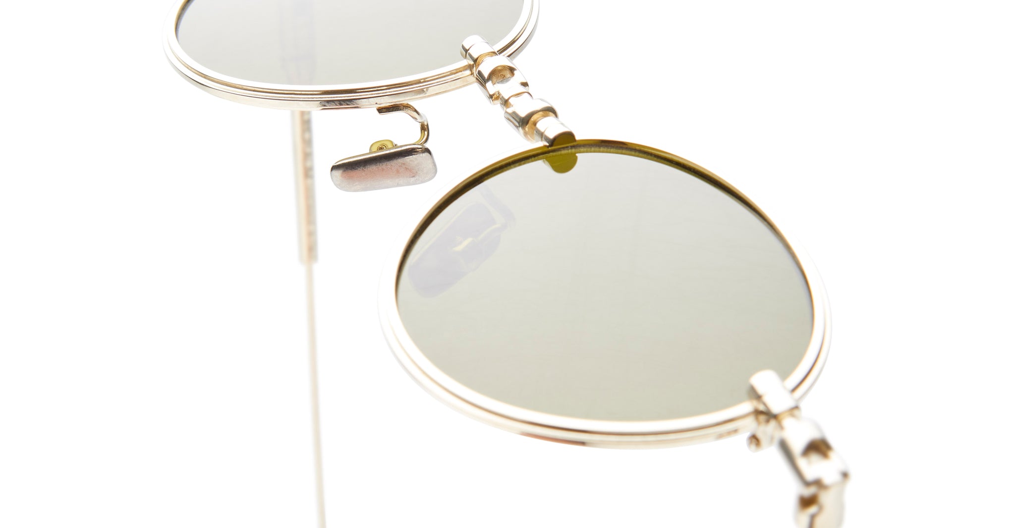 Close-up of Kuboraum H67 round sunglasses, featuring gold frames and green lenses, front angle.