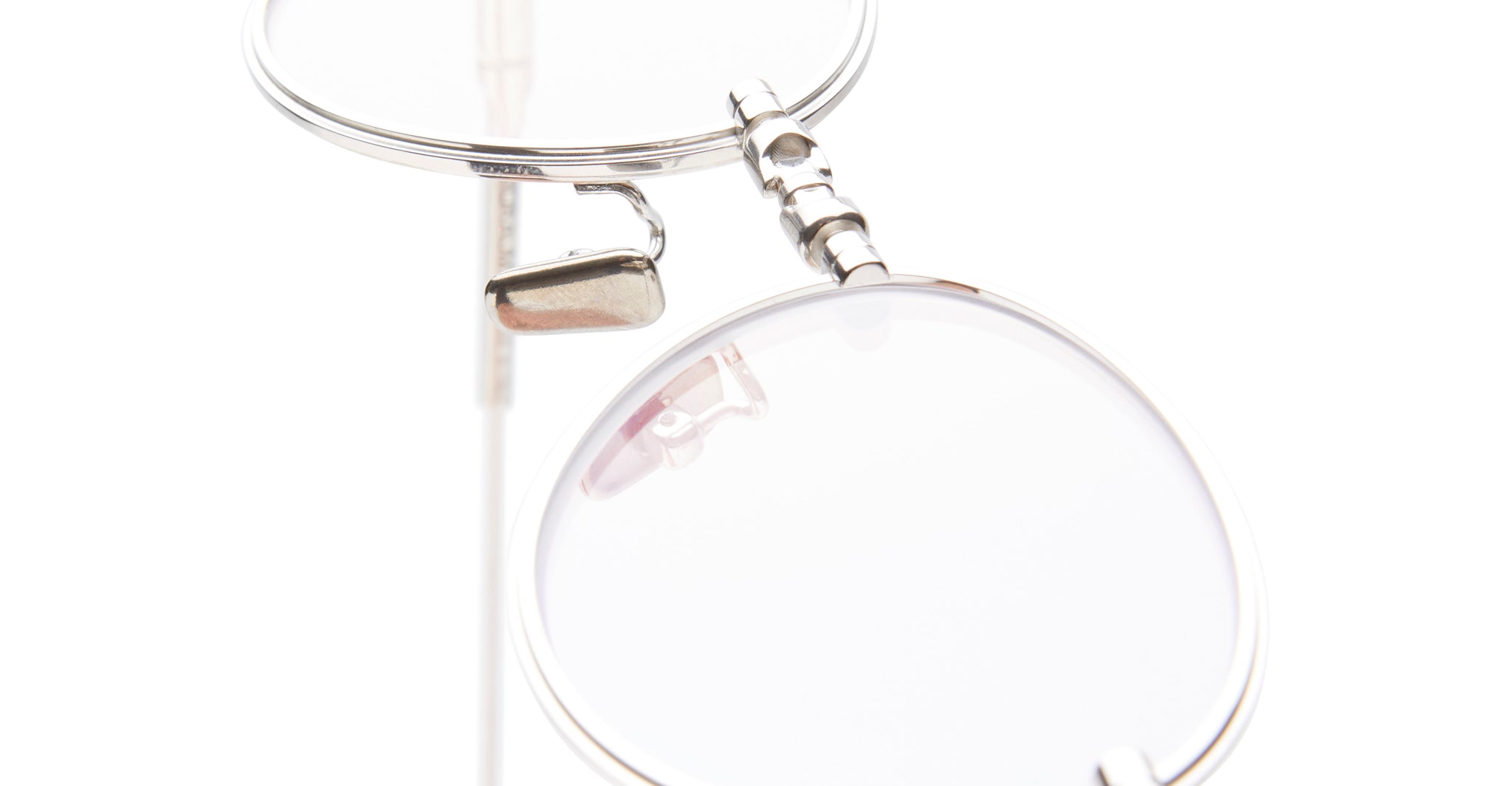 Close-up of Kuboraum H67 eyeglasses by KUBORAUM, featuring silver rims and clear lenses, front view.