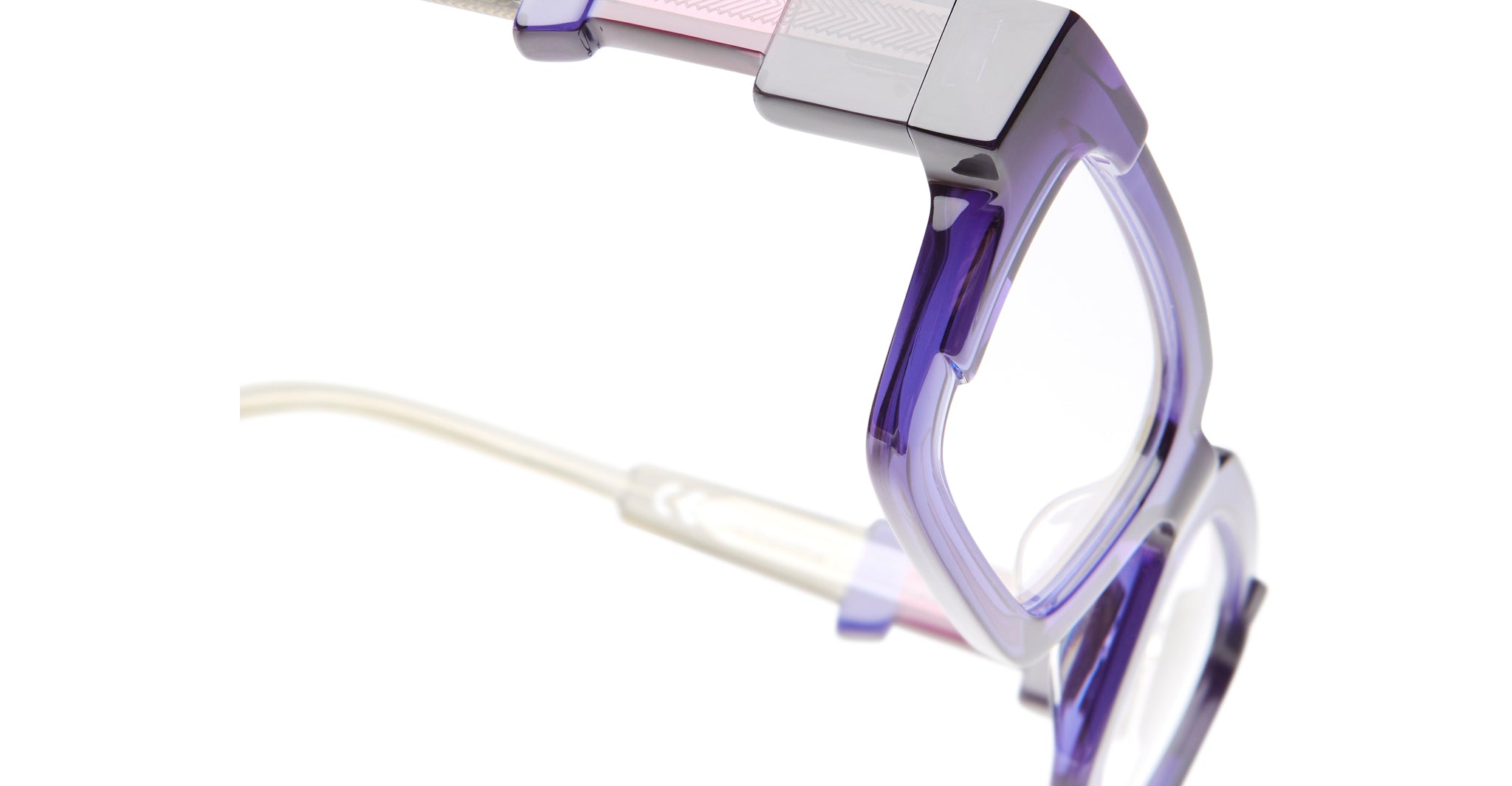 Close-up of KUBORAUM I01 eyeglass frames in purple and pink with clear temples, front view.