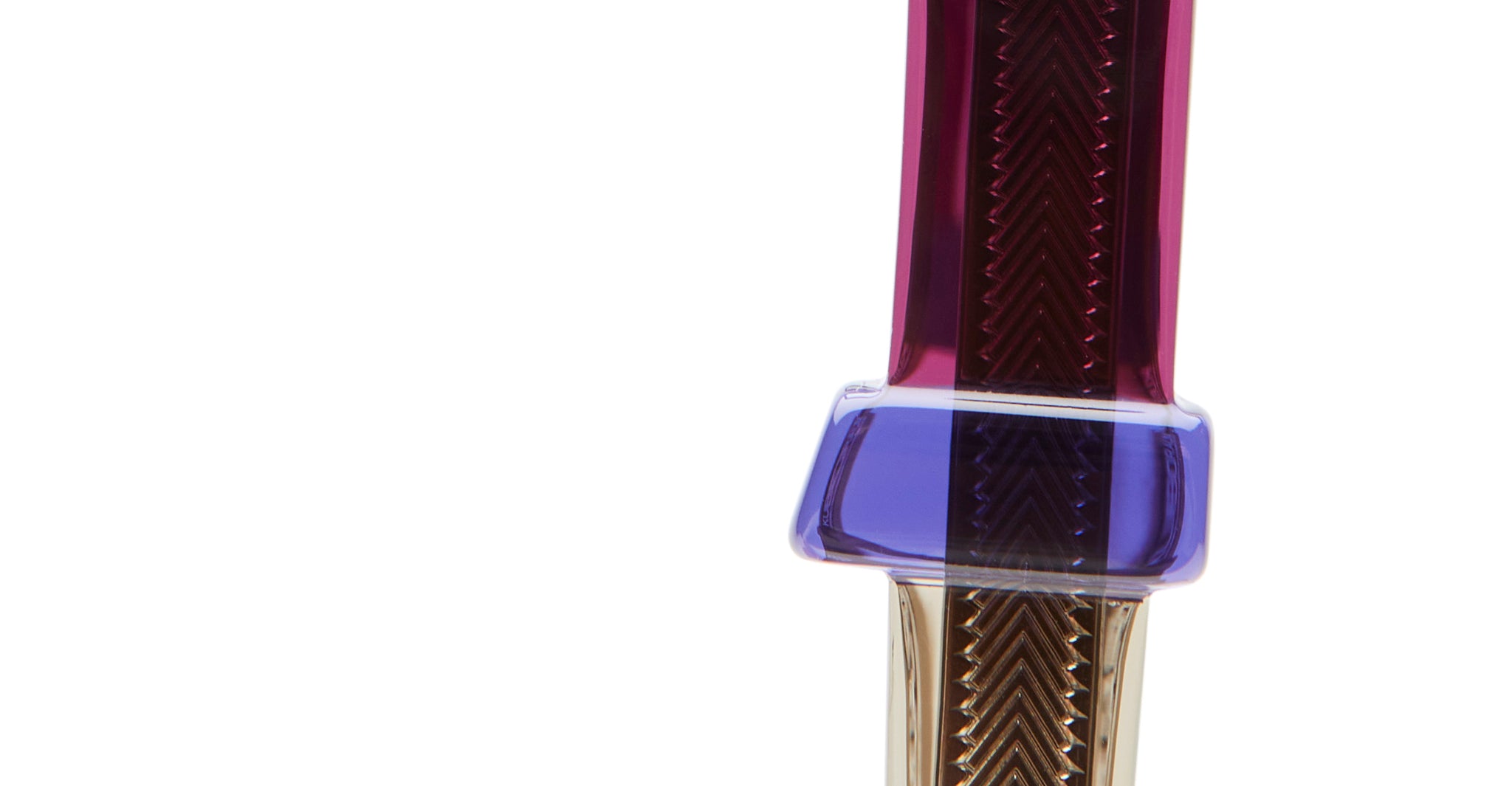 Close-up of KUBORAUM I01 eyeglasses showing a zigzag pattern in iridescent purple, blue, and brown on a white frame.