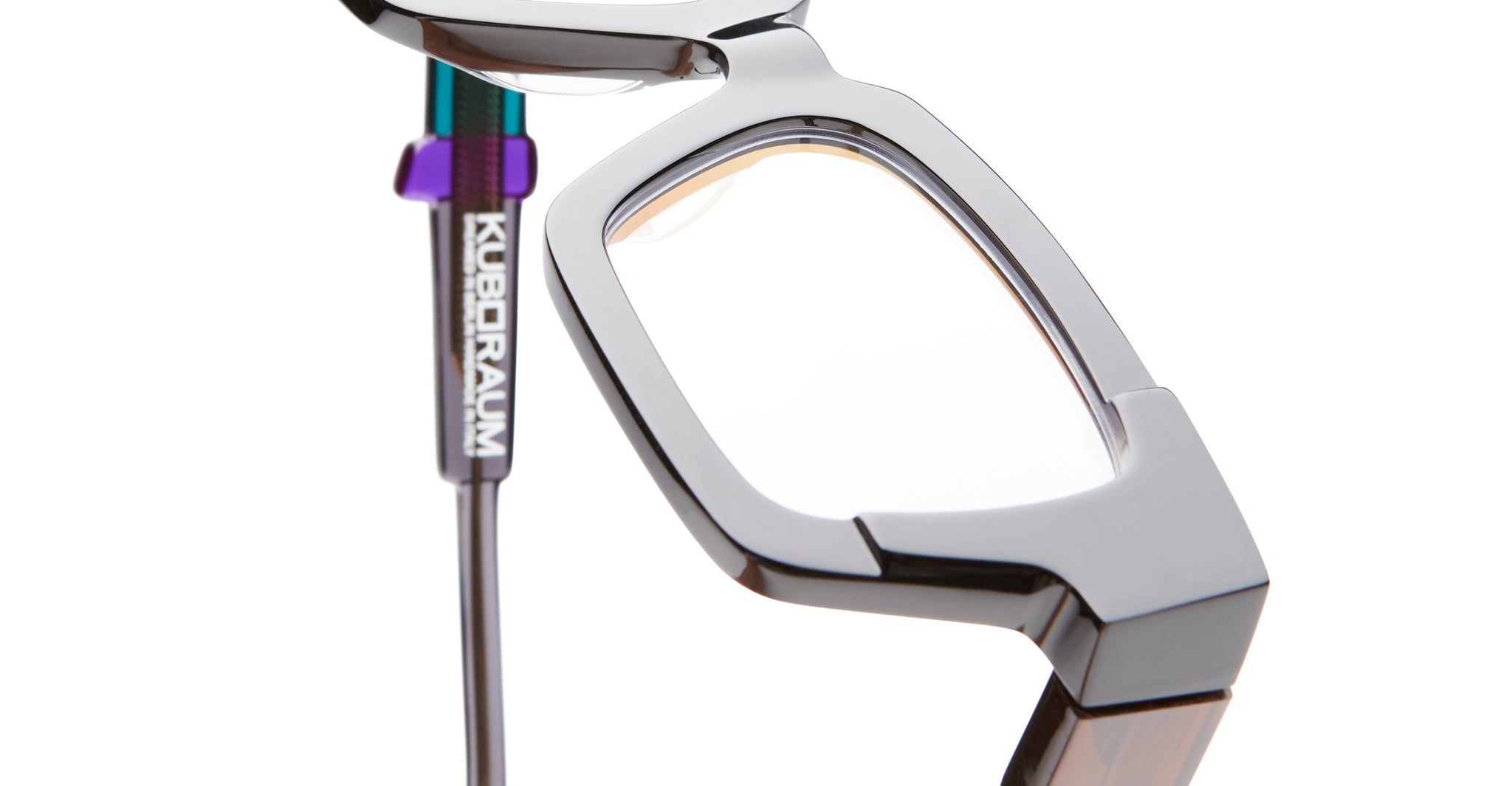 Close-up of KUBORAUM I01 eyeglasses showing geometric frame design and distinctive acetate temple detailing.