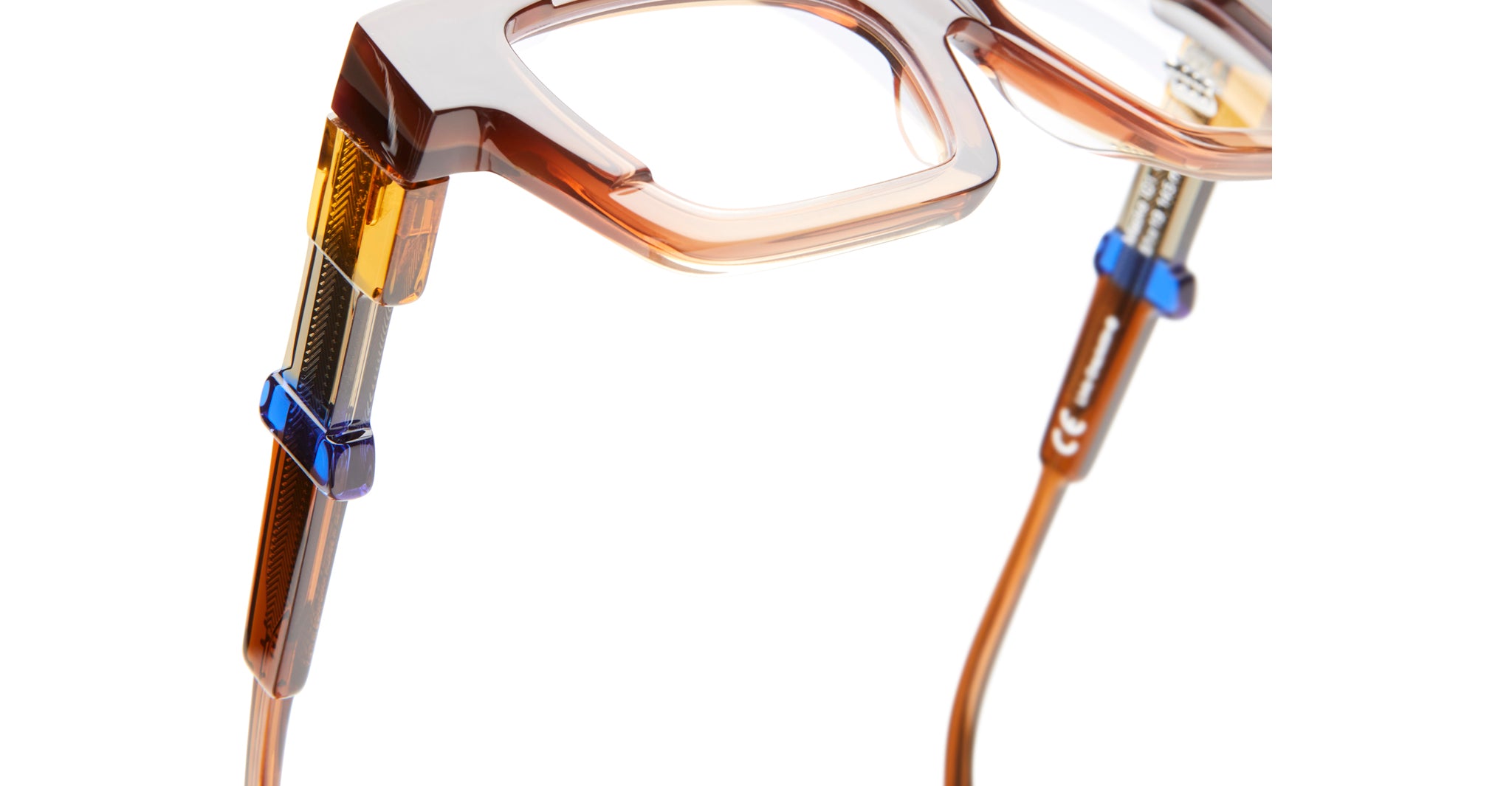 Close-up of KUBORAUM I01 brown eyeglasses with metallic and blue temples, front angle.