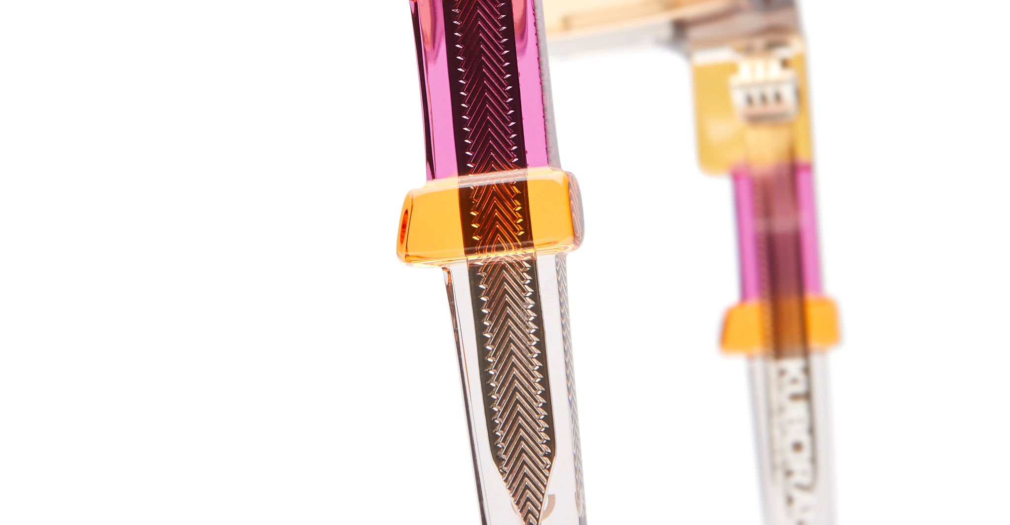 Close-up view of KUBORAUM Kuboraum I01 fountain pen showing purple ink, orange accents, visible nib, and internal mechanism.