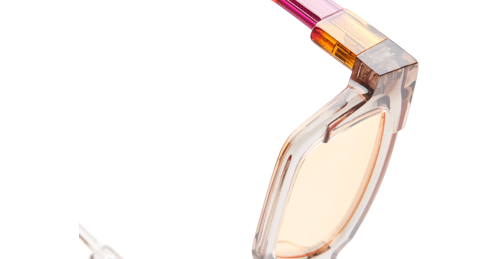 Close-up of KUBORAUM I01 eyeglasses with translucent peach lenses and gradient frames, front view.