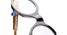 Close-up of KUBORAUM I02 round black acetate eyeglasses with brown temple arms, viewed from the side.