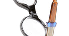Close-up of KUBORAUM I02 eyeglasses, round black frames with amber and blue temple accents, brand and model visible front view.