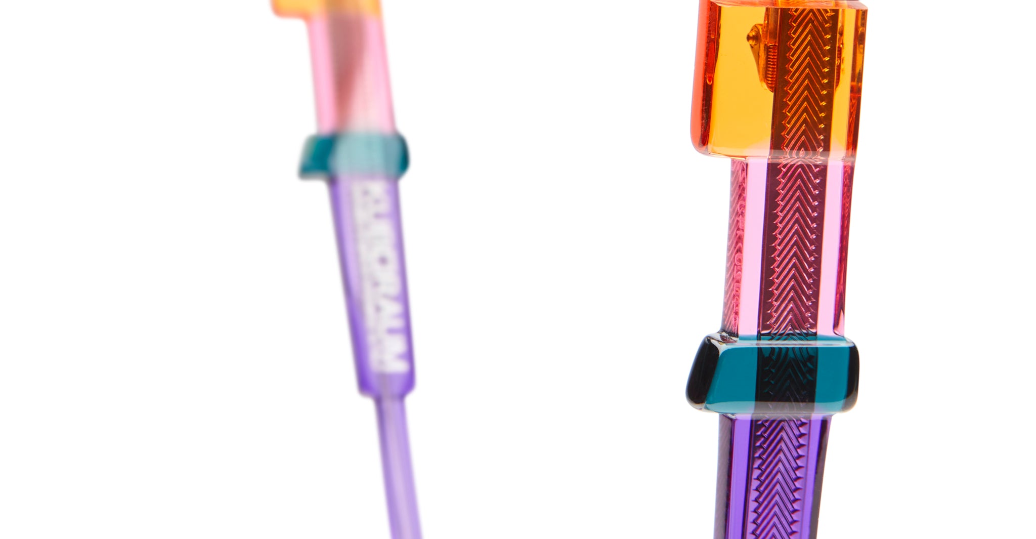 Close-up of KUBORAUM I02 sunglasses, showing vibrant translucent geometric frames from the front.