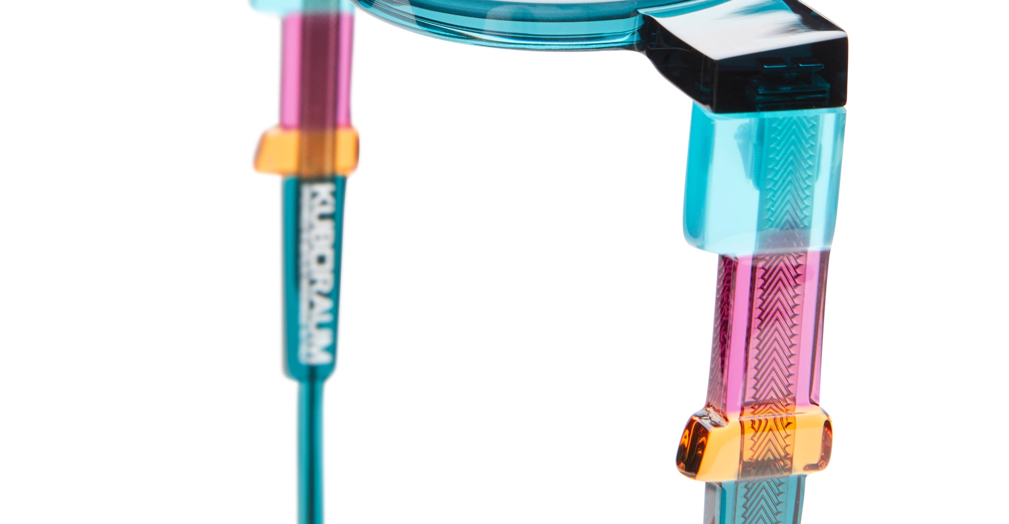 Close-up of KUBORAUM I02 eyeglasses with geometric patterns and colorful translucent frames, showing detailed front view.