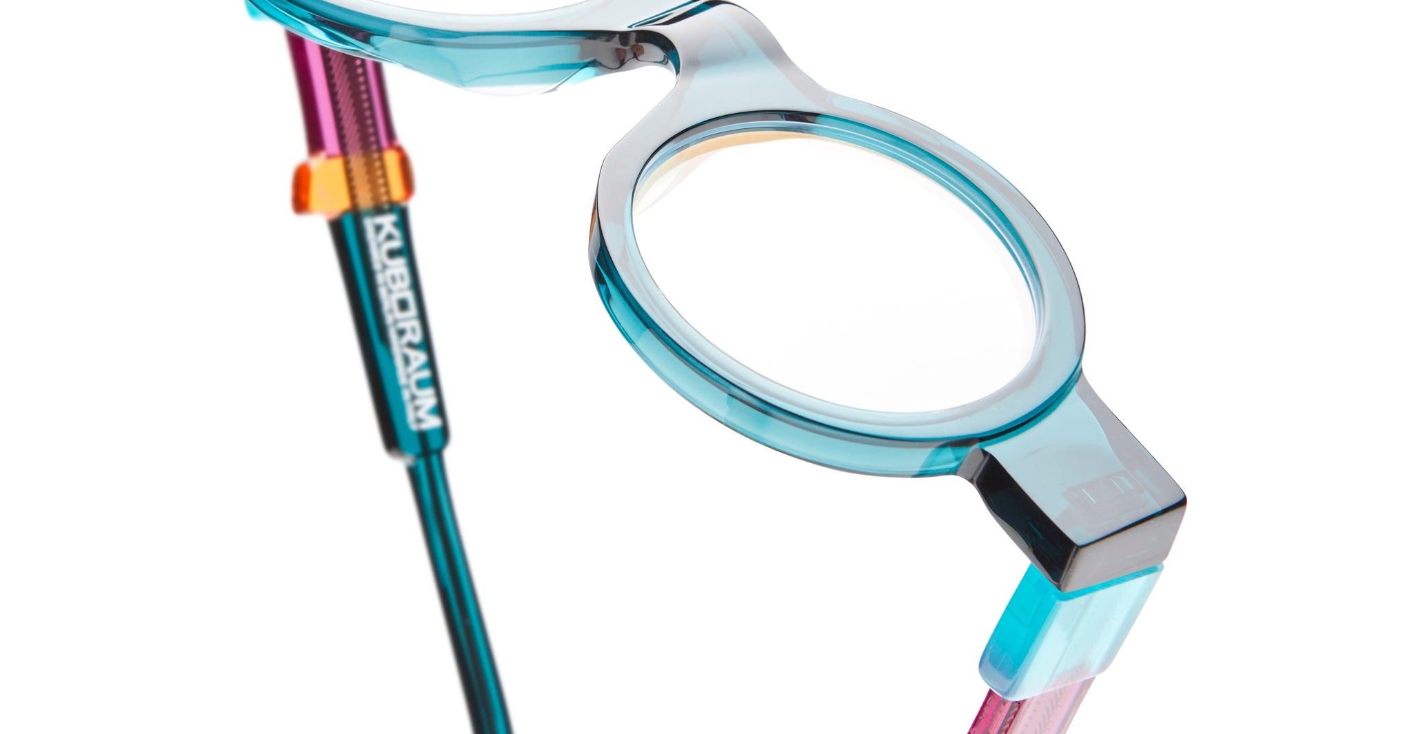 Close-up view of Kuboraum I02 blue round eyeglasses frames with metallic hinges and KUBORAUM logo on the temple.