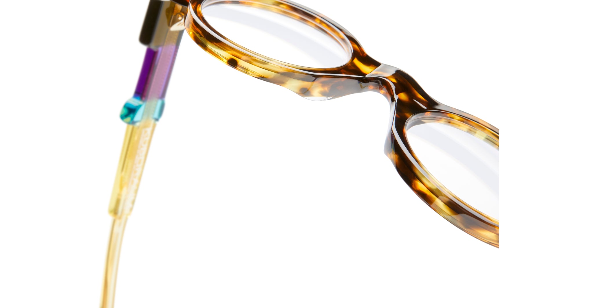 Close-up of KUBORAUM I02 tortoiseshell eyeglasses featuring bold multicolored temples, front view.