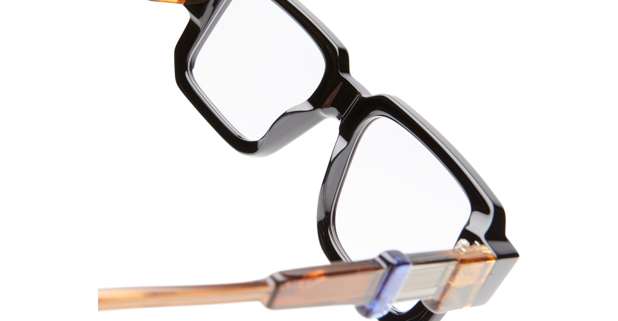 Close-up of KUBORAUM Kuboraum I03 eyeglasses, black rectangular frames with brown and blue temples, front angle view.