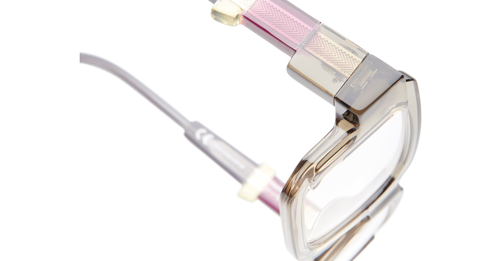 Close-up of Kuboraum I03 eyeglasses by KUBORAUM, transparent frames with pink-gold arms, shown from the front.