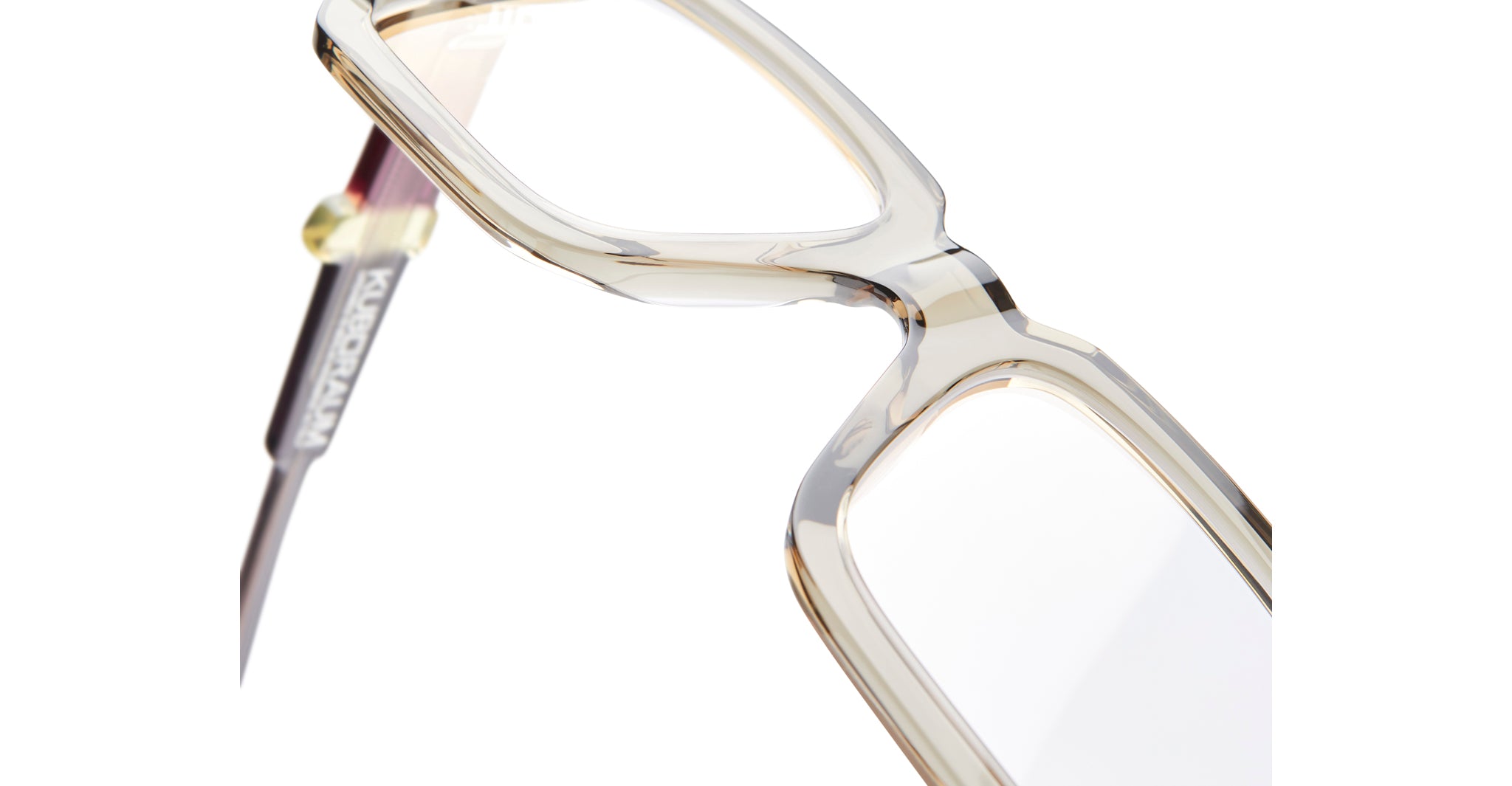 Close-up of KUBORAUM Kuboraum I03 eyeglasses showing transparent rectangular frames and metallic arms, front angle.