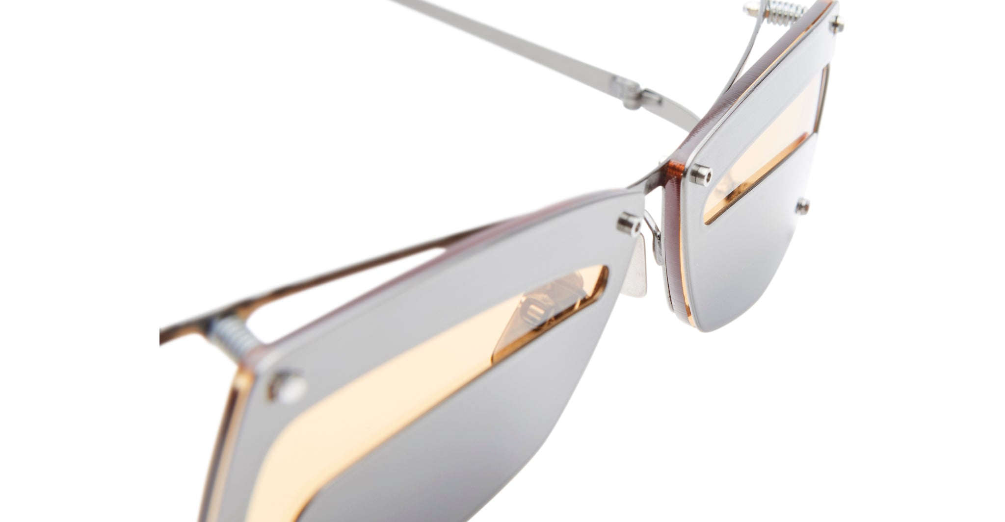 Close-up of Kuboraum I50 sunglasses featuring metallic silver frames, yellow-tinted lenses, and detailed hinges and rim design, set against a white background.