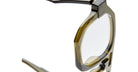 Close-up of the top corner of a translucent olive green Kuboraum K33 eyeglass frame, highlighting the clear lenses and a portion of the temple hinge.