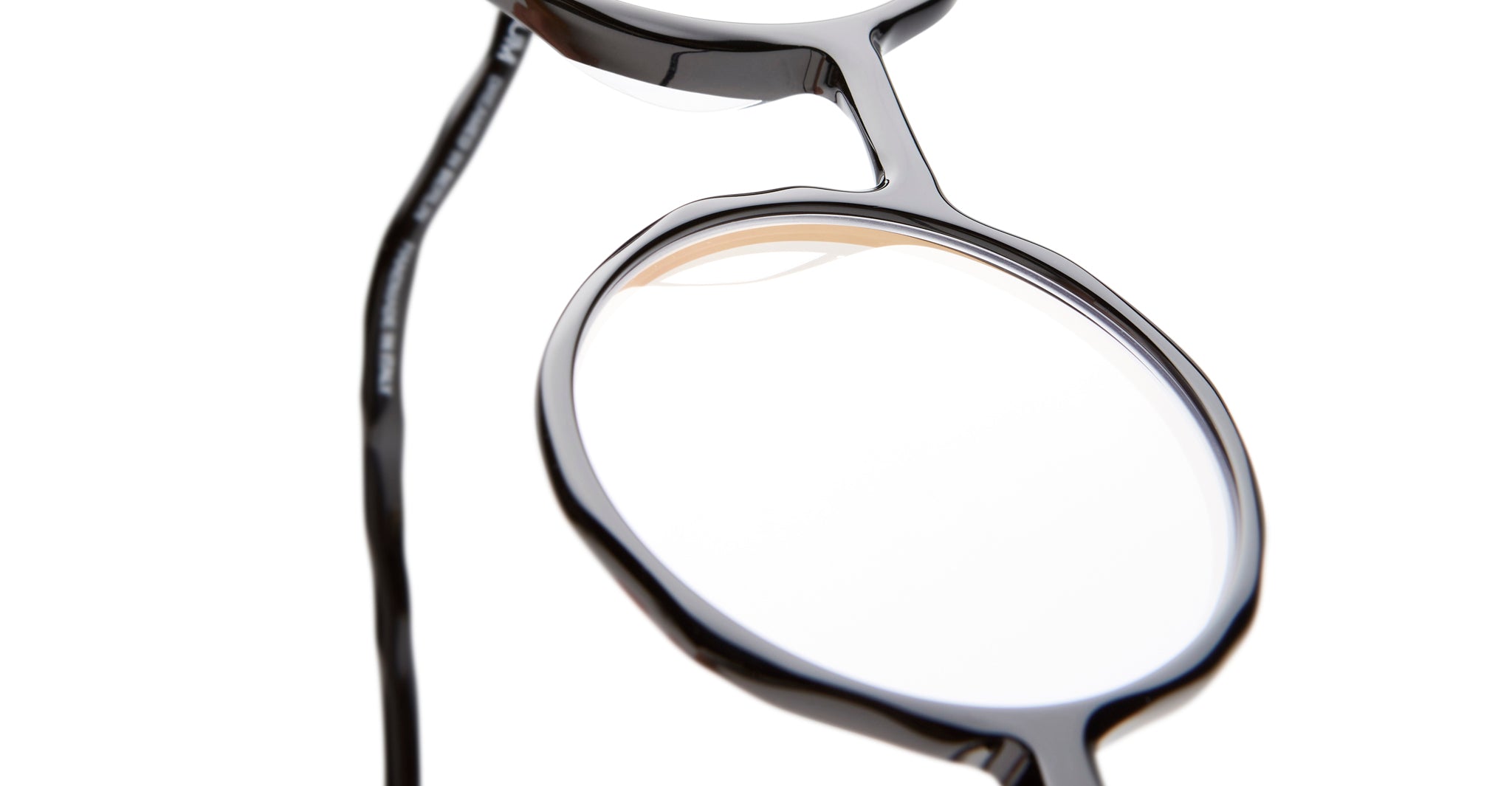 Close-up of KUBORAUM L11 round black eyeglasses with clear lenses, front view. Brand and model name visible.